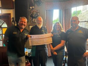 The Queens Arms providing Torbay Hospital Radio with a cheque of the funds they raised for the charity